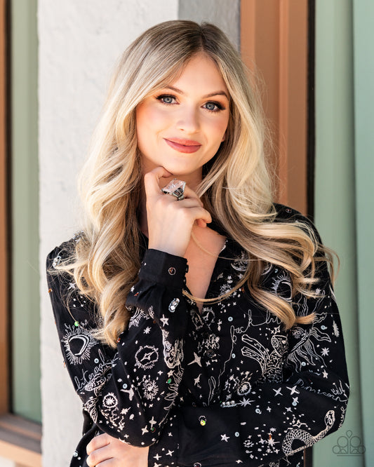 A white rhinestone dotted star twinkles behind a glassy pane that seemingly floats atop the pronged frame, resulting in a stellar statement piece. Features a stretchy band for a flexible fit. Sold as one individual ring.